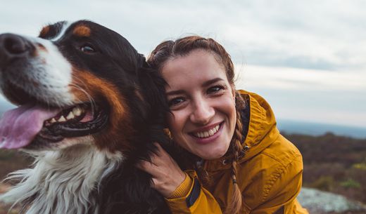 Young woman hugging her dog.