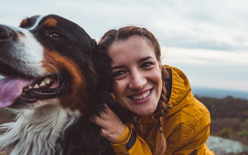 Young woman hugging her dog.