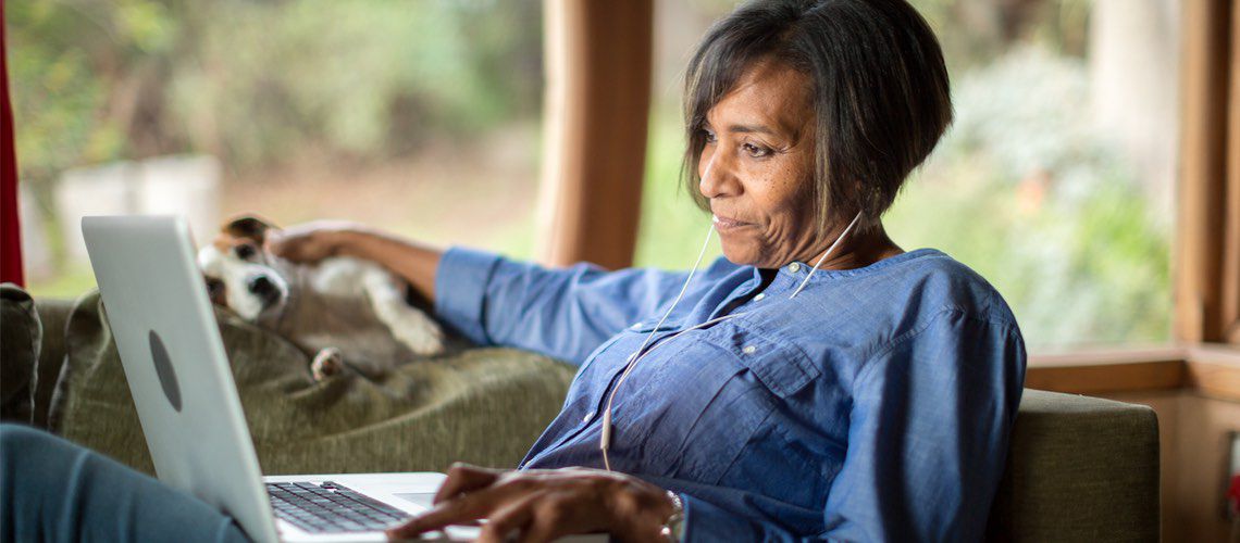 Black woman working on a laptop.