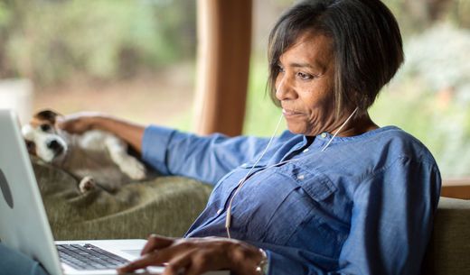 Black woman working on a laptop.