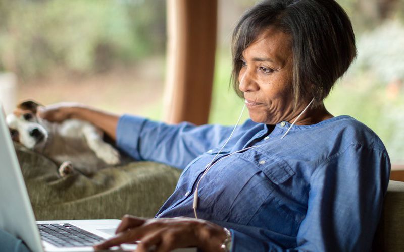 Black woman working on a laptop.