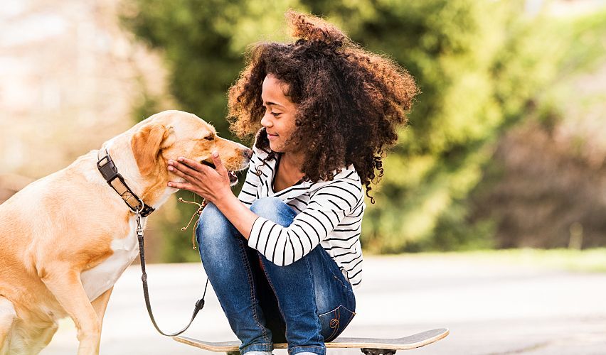 African American girl with her dog.