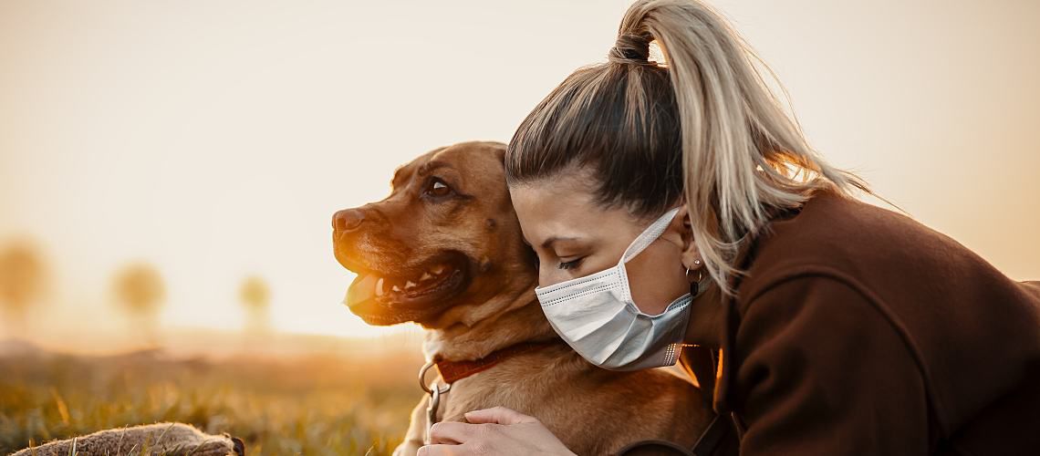 A woman sick with COVID-19 hugs her dog.