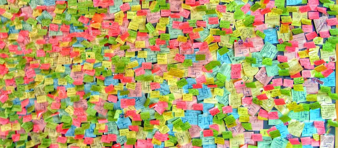 Thousands of colorful post-its on a wall.