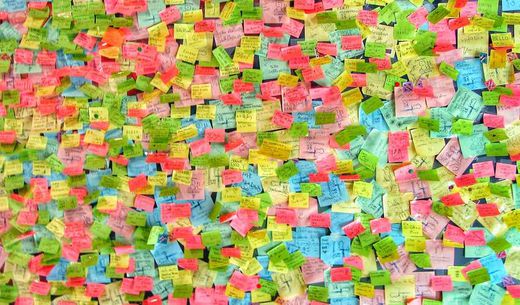 Thousands of colorful post-its on a wall.