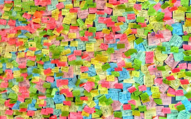 Thousands of colorful post-its on a wall.