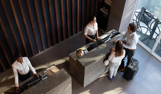 Guests checking in at the hotel reception.