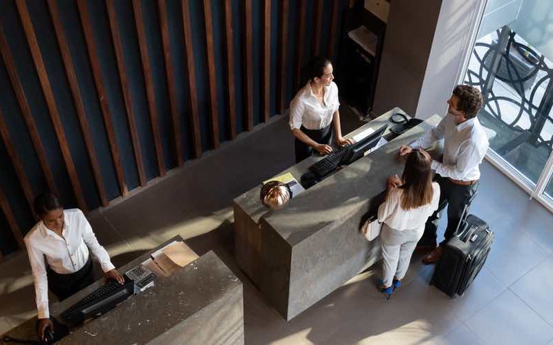 Guests checking in at the hotel reception.